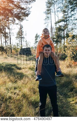 Happy Fathers Day. Dad And Son On A Walk In The Forest In Sunny Weather. Family Leisure. The Father 