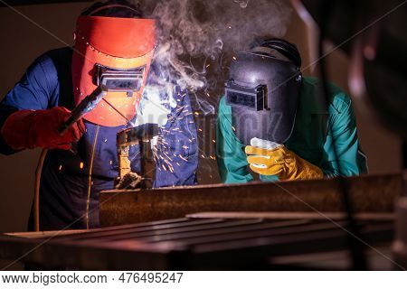 Metal Welding Steel Works Using Electric Arc Welding Machine To Weld Steel At Factory. Metalwork Man