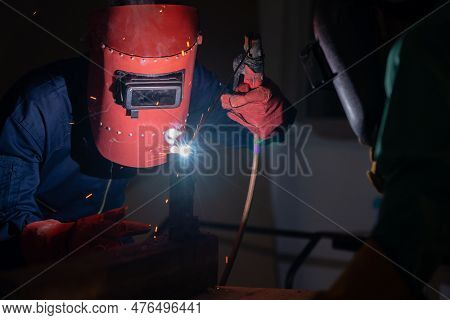 Metal Welding Steel Works Using Electric Arc Welding Machine To Weld Steel At Factory. Metalwork Man