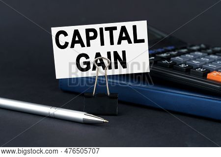 Business Concept. On The Table Is A Notebook, A Calculator, A Pen And A Business Card With The Inscr