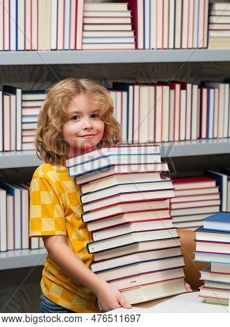 Smart Pupil. Kid Reads Books In The Library. Schoolboy With Book In School Library. Literature For R