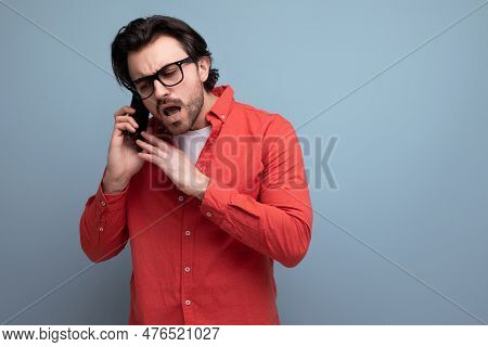 Handsome Dark-haired 30s Man In Red Shirt Talking On The Phone