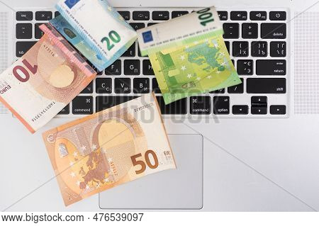 Us Hundred Dollar Bills On White Modern Computer Keyboard.