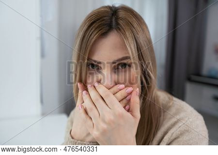 Beautiful Young Woman Close Her Mouth On Gray Background