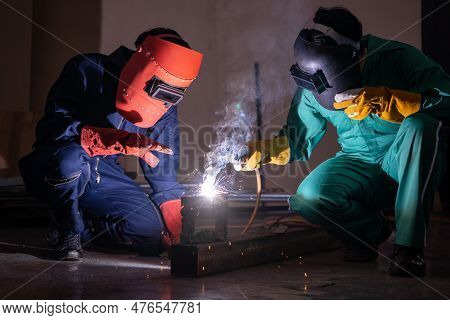 Metal Welding Steel Works Using Electric Arc Welding Machine To Weld Steel At Factory. Metalwork Man