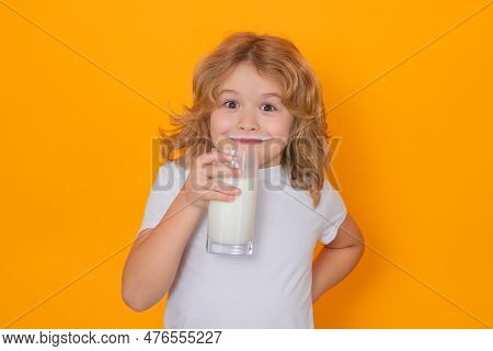 Child With Glass Of Milk On Studio Yellow Background. Kid With Milk Moustache. Fun Portrait Of Cute 