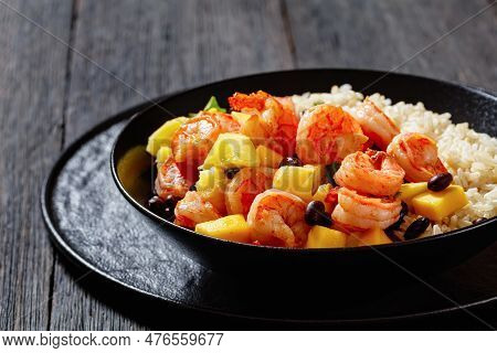 Caribbean Grilled Shrimps With Black Beans, Mango Pineapple Salsa Served With Brown Rice In Black Bo