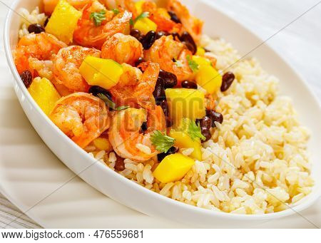 Close-up Of Caribbean Grilled Shrimps With Black Beans, Mango Pineapple Salsa Served With Brown Rice
