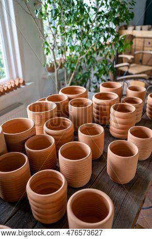 Terracotta Pots In Different Sizes In Plant Shop. Traditional Handmade Clay Pots And Earthenware Jar