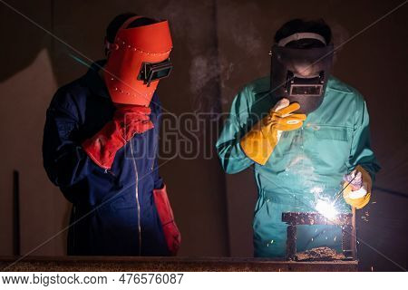 Metal Welding Steel Works Using Electric Arc Welding Machine To Weld Steel At Factory. Metalwork Man