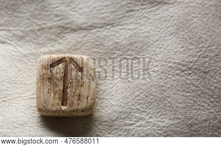 Wooden Rune Teiwaz On Leather, Closeup. Space For Text