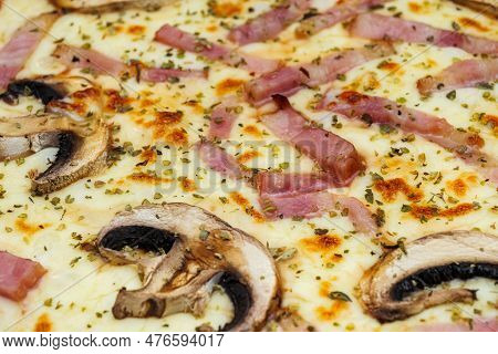 Pizza With Mushrooms, Ham, Cheese And Oregano. Fresh Baked Pizza Close-up.