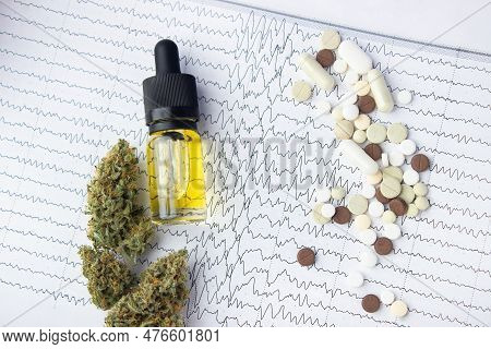 Against The Background Of The Results Of Electroencephalography Lie A Glass Bottle With Yellow Cbd O