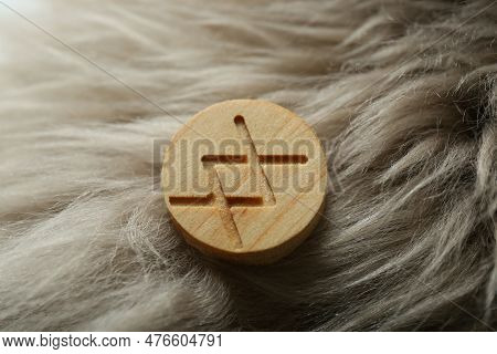 Wooden Rune Inguz On Light Faux Fur, Closeup