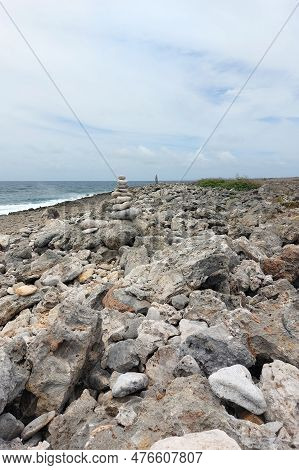 A Tall Tower Of Flat Stones Stands On The Seashore In Cloudy Weather. Stone Shore, Neatly Stacked St