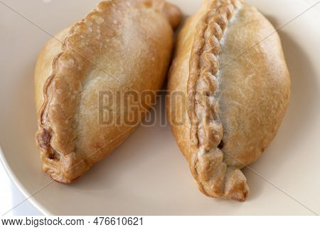 Side View Of Traditional Lithuanian Pastries Filled With Mutton, Chopped Meat Or Mushrooms On The Br