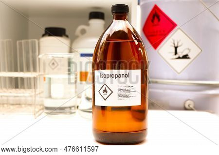 Isopropanol In Glass, Hazardous Chemicals And Symbols On Containers In Industry Or Laboratory