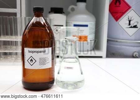 Isopropanol In Glass, Hazardous Chemicals And Symbols On Containers In Industry Or Laboratory