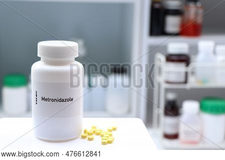 Metronidazole Pill In White Bottle, Pill Stock, Medical Or Pharmacy Concept