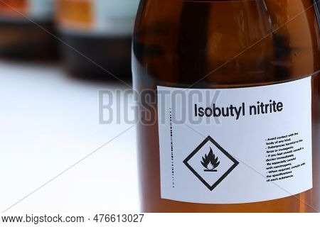 Isobutyl Nitrite In Glass, Hazardous Chemicals And Flammable Symbols On Containers In Industry Or La