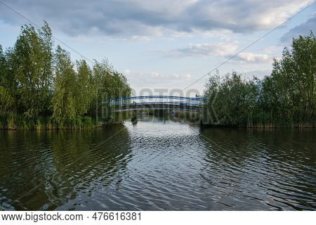 Bridge Over A T-junction Of The Water With Trees On The Sides