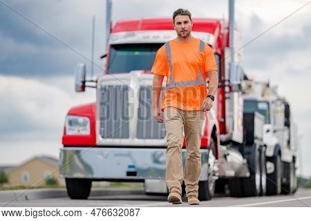 Men Driver Near Lorry Truck. Man Owner Truck Driver In Safety Vest Near Truck. Serious Hispanic Man 