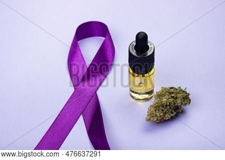 Glass Bottle With Cbd Oil Extract.  Nearby Is A Dry Bud Of Medical Marijuana.  Epilepsy Day Symbol F