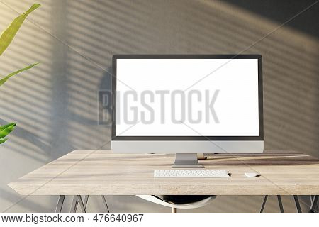 Front View Of A Home Workplace With Wooden Desk With Blank White Screen Modern Computer On Dark Wall