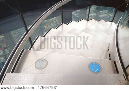 White Spiral Staircase For Going Down, With Labels Showing Which Side To Go Up And Go Down