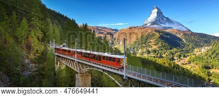 Zermatt, Switzerland. Gornergrat Red Tourist Train On The Bridge And Matterhorn Peak Panorama In Swi