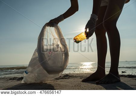 Save Ocean. Volunteer Pick Up Trash Garbage At The Beach And Plastic Bottles Are Difficult Decompose