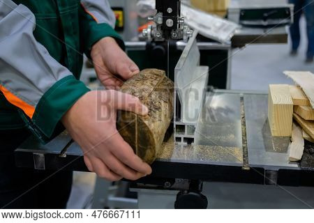 Professional Man Carpenter Using Electric Bandsaw Tool, Cutting Piece Of Wood At Workshop - Close Up