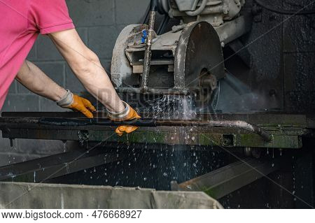 A Worker Cuts Granite. The Cutter Cuts Granite. Stone Processing Machine. Stone Cutting At The Facto
