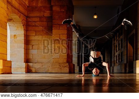 Young Teenage White Boy Dances Break Dance In The Old Streets Of A City. Modern Dance. B-boy. Hip Ho