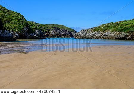 View On Playa De Poo During Low Tide Near Llanes, Green Coast Of Asturias, North Spain With Sandy Be