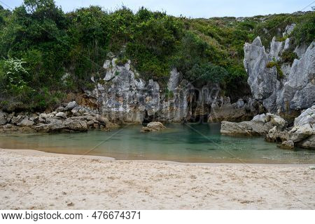Playa De Gulpiyuri, Flooded Sinkhole With Inland Beach Near Llanes, In Asturias Northern Spain, Arou