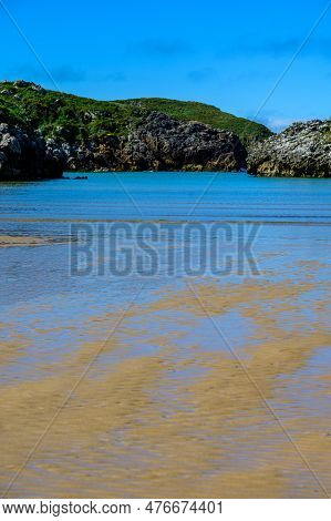 View On Playa De Poo During Low Tide Near Llanes, Green Coast Of Asturias, North Spain With Sandy Be