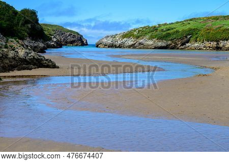 View On Playa De Poo During Low Tide Near Llanes, Green Coast Of Asturias, North Spain With Sandy Be