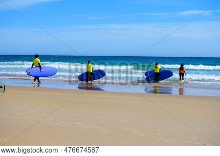 Young Surfers Train On Playa De Palombina Las Camaras In Celorio, Green Coast Of Asturias, North Spa