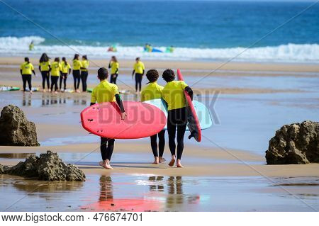 Young Surfers Train On Playa De Palombina Las Camaras In Celorio, Green Coast Of Asturias, North Spa
