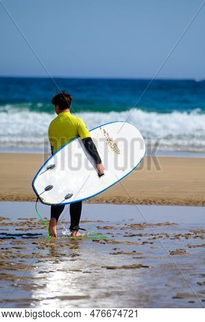 Young Surfers Train On Playa De Palombina Las Camaras In Celorio, Green Coast Of Asturias, North Spa