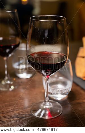 Dinner With Glass Of Dry Red Wine In Italian Osteria Restaurant