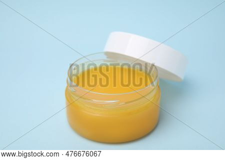 Open Jar Of Petrolatum On Light Blue Background, Closeup