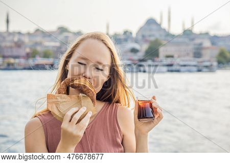 Woman In Istanbul Having Breakfast With Simit And A Glass Of Turkish Tea. Glass Of Turkish Tea And B