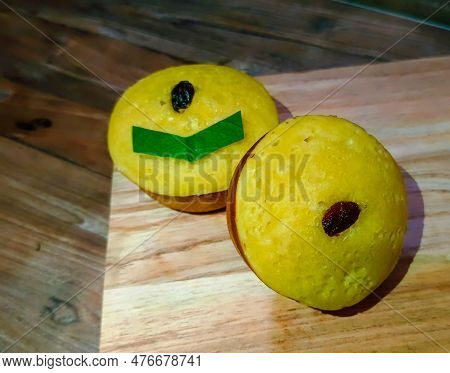 Mud Cake With Raisin Topping On A Wooden Cutting Board