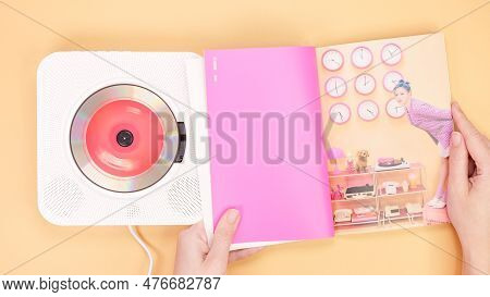 Hands Holding Twice Between 1 And 2 Mini Album Photobook On Yellow. Music Cd Player. South Korean Gi