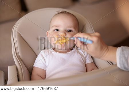 Cute Baby Boy Sitting In High Chair All Messy And Staied Refusing To Eat Porridge