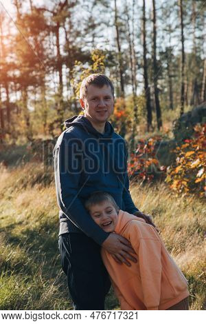 Happy Fathers Day. Dad And Son On A Walk In The Forest In Sunny Weather. Family Leisure. The Father 