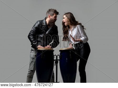 Couple Hitting On Conga Drums Isolated On Gray Background. Conga Drums.