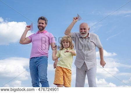 Active Family Leisure With Kids. Boy Son With Father And Grandfather With A Toy Airplane Plays On Su